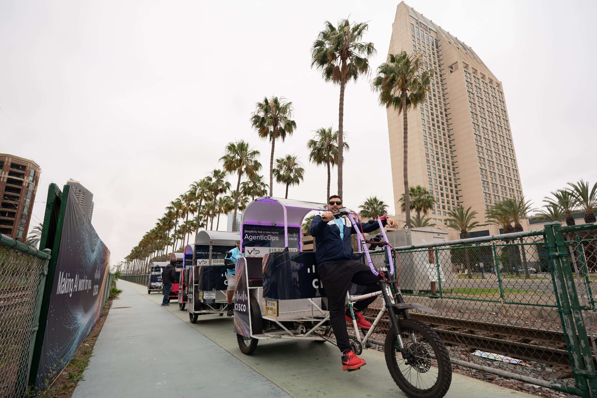 Cisco-branded electric VIP pedicabs lined up along the bike path by the San Diego Convention Center